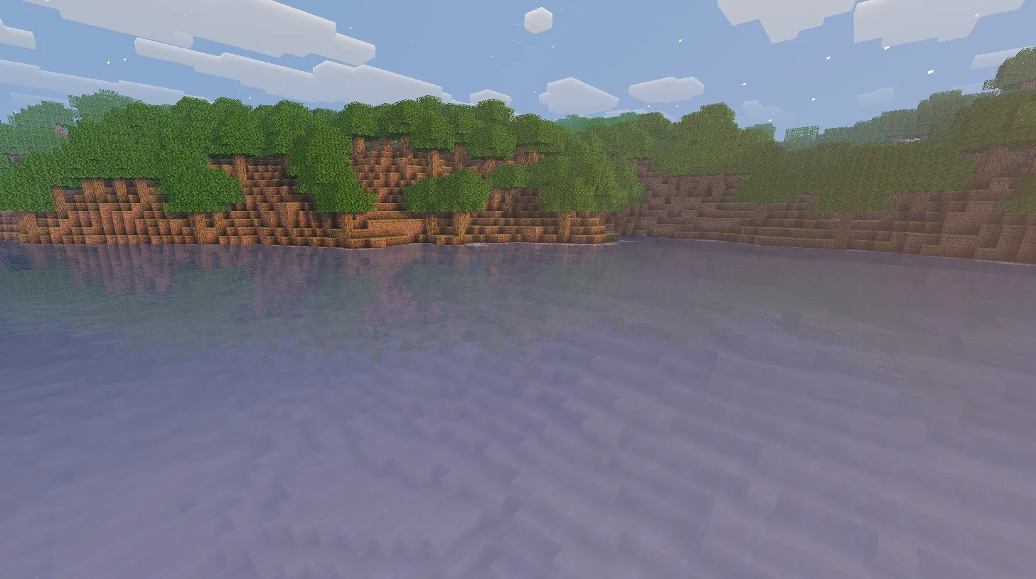 Water surface at sunrise with warm orange reflections